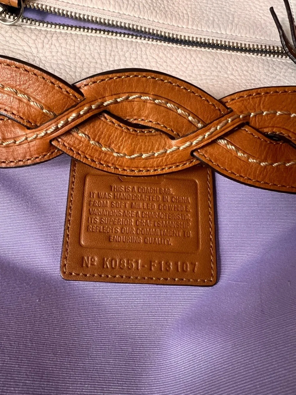 Coach Soho White Pebbled Leather Hobo bag features a distinctive braided handle